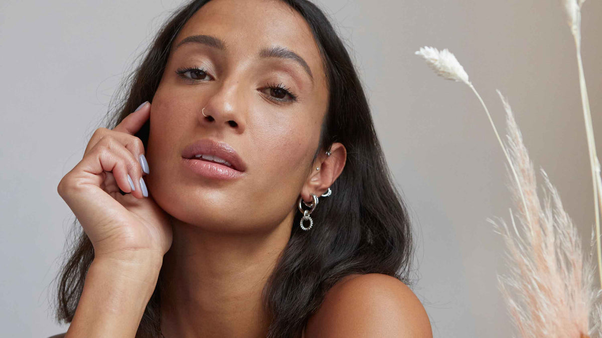 Woman wearing silver nature themed jewellery from Astrid & Miyu's Gaea Collection. Perfect for the autumn & winter.