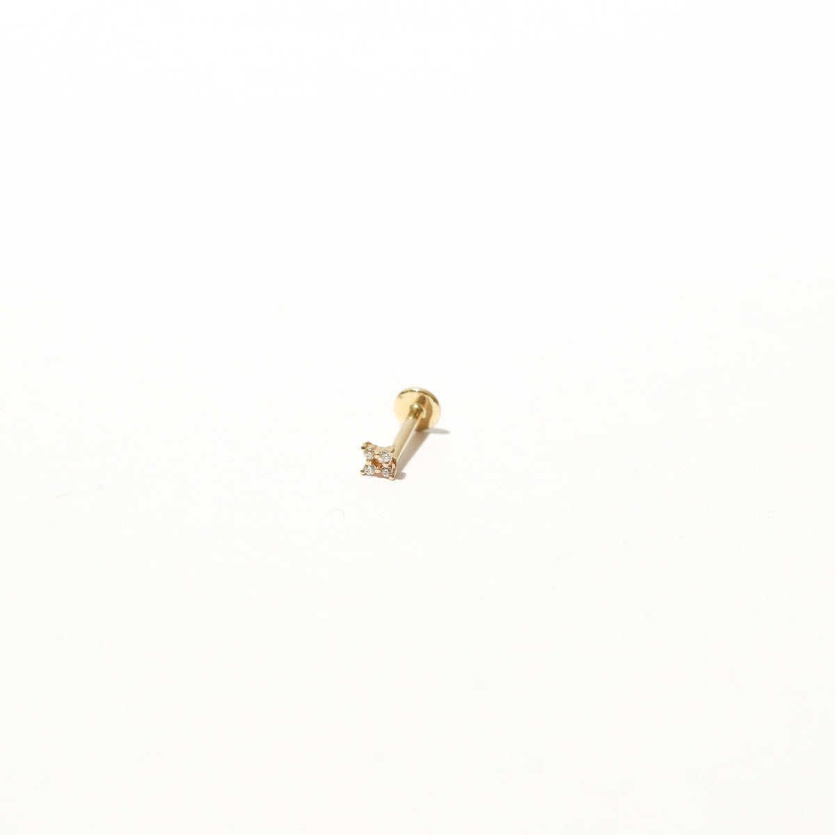 Cosmic Star Crystal Piercing Stud in Solid Gold flat lay shot