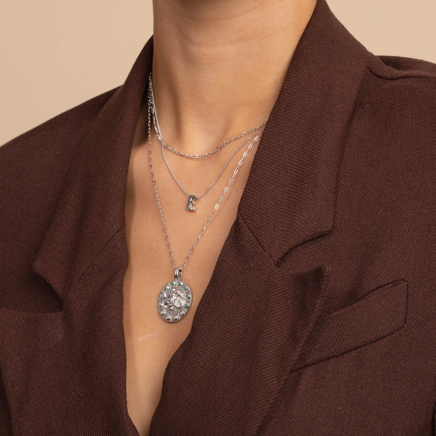 Capricorn Bold Zodiac Pendant Necklace in silver worn with necklaces