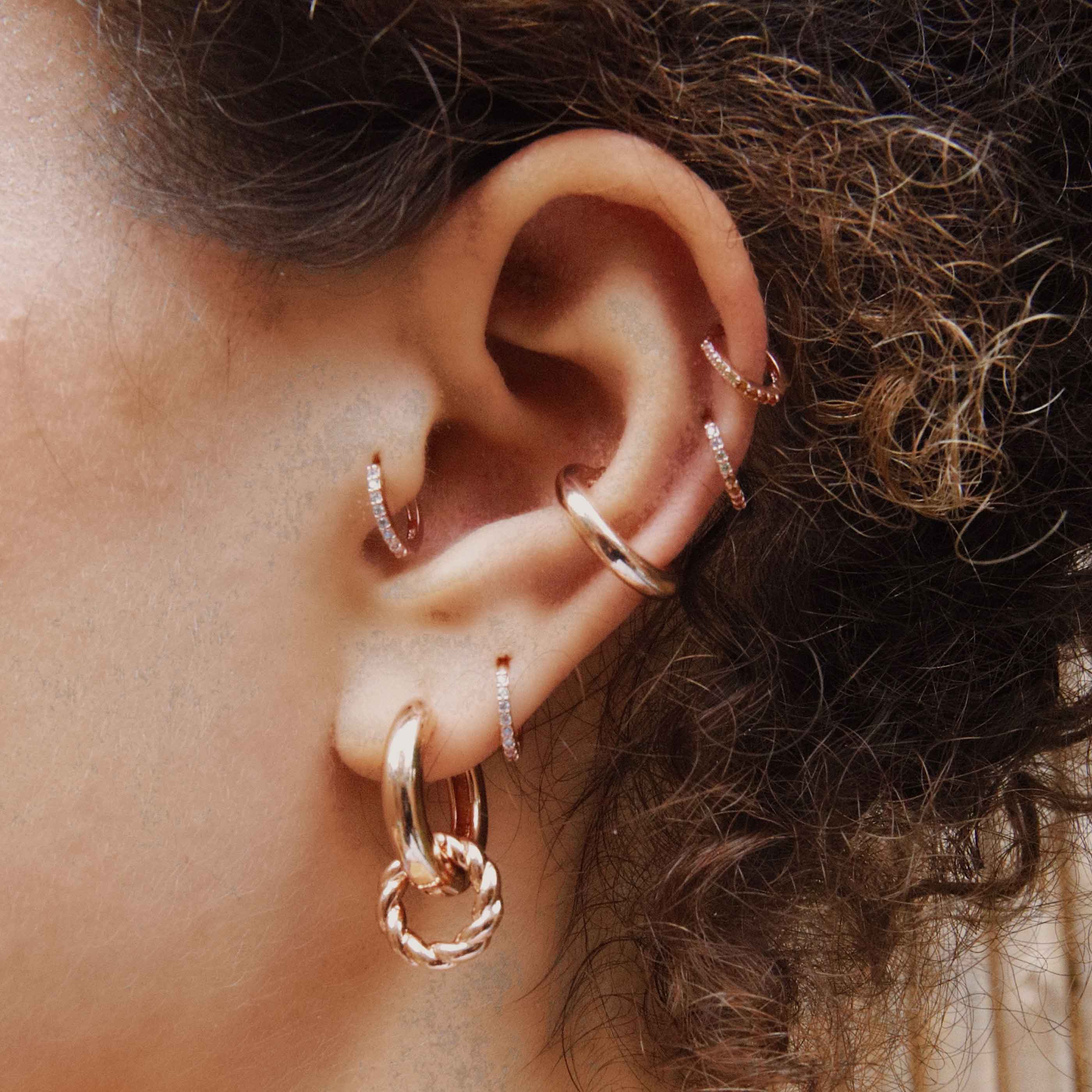 Crystal Jewelled Huggies in Rose Gold worn in tragus and second lobe piercing