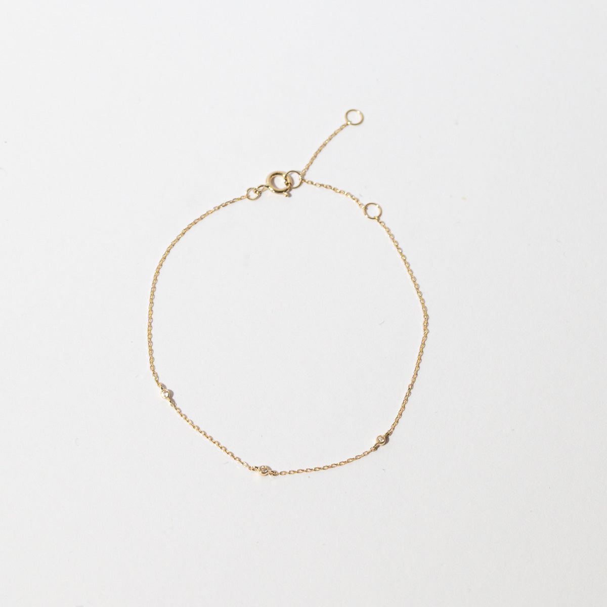 Topaz Charm Bracelet in Solid Gold flat lay