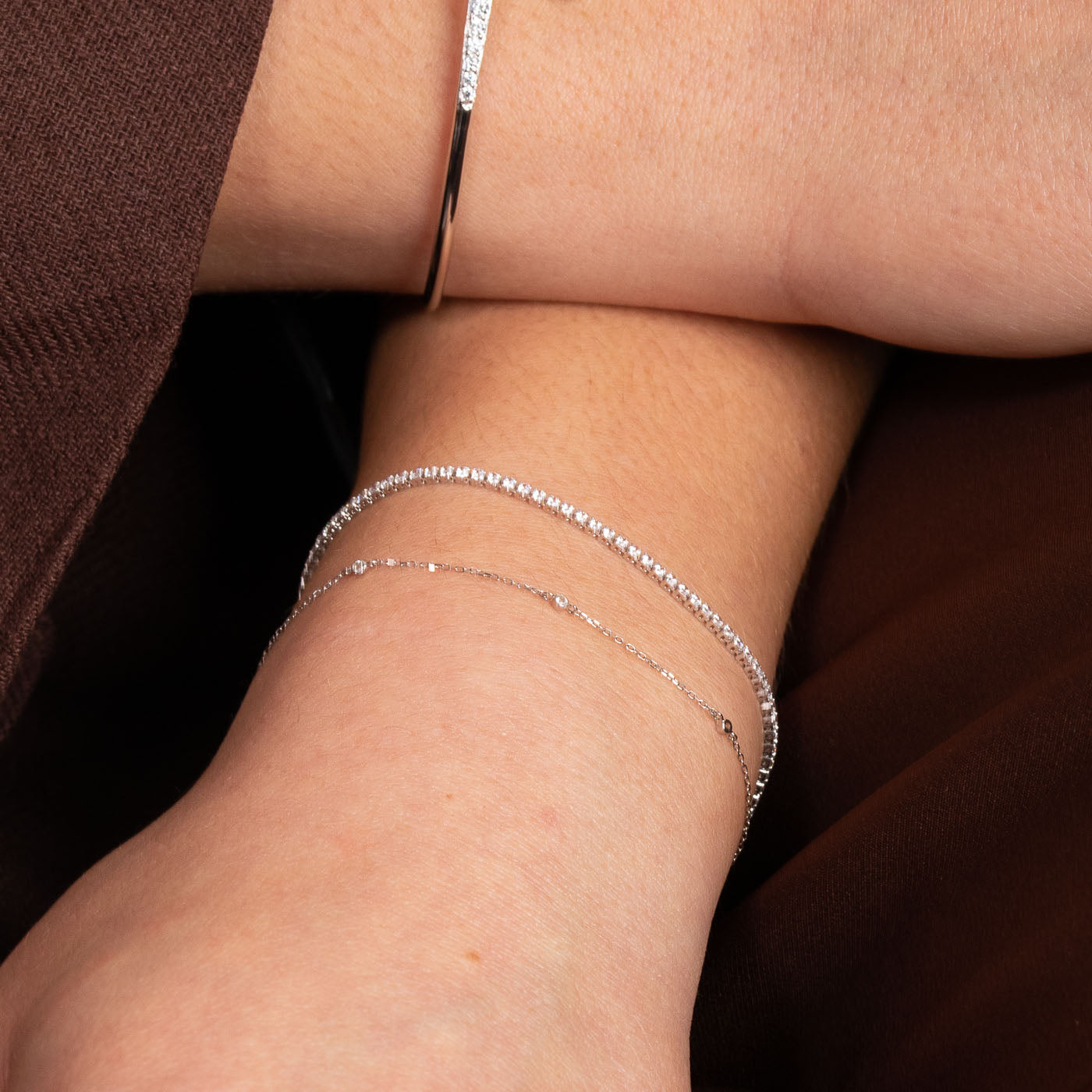 Topaz Charm Bracelet in Solid White Gold worn with Tennis bracelet in silver
