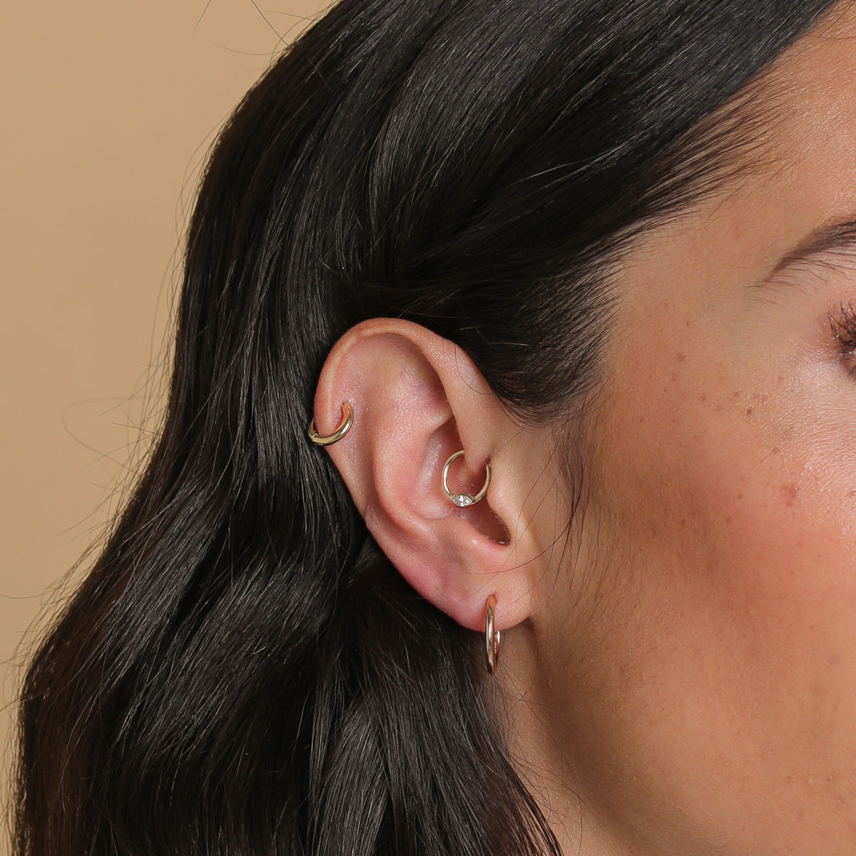 Essential 11.5mm Hoop in Gold worn in lobe piercing
