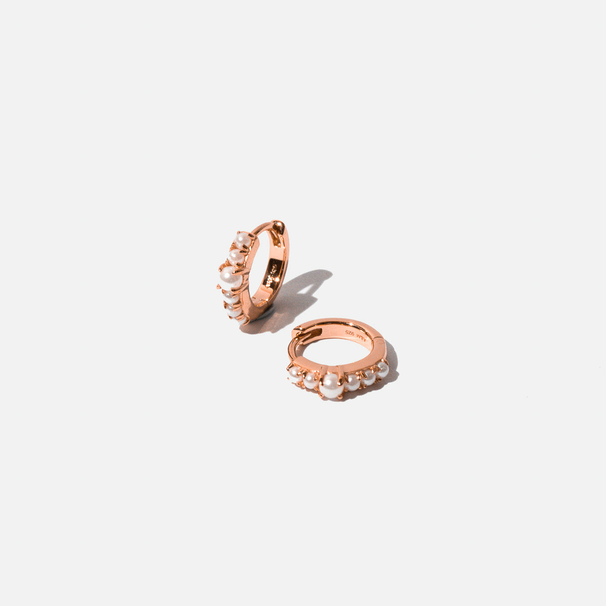 Radiant Pearl Huggies in Rose Gold flat lay
