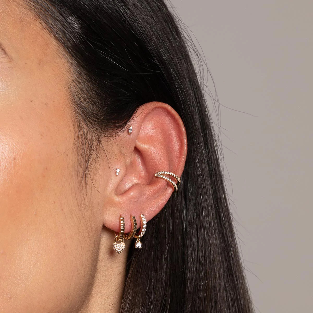 Charm Crystal Huggies in Gold worn with other earrings