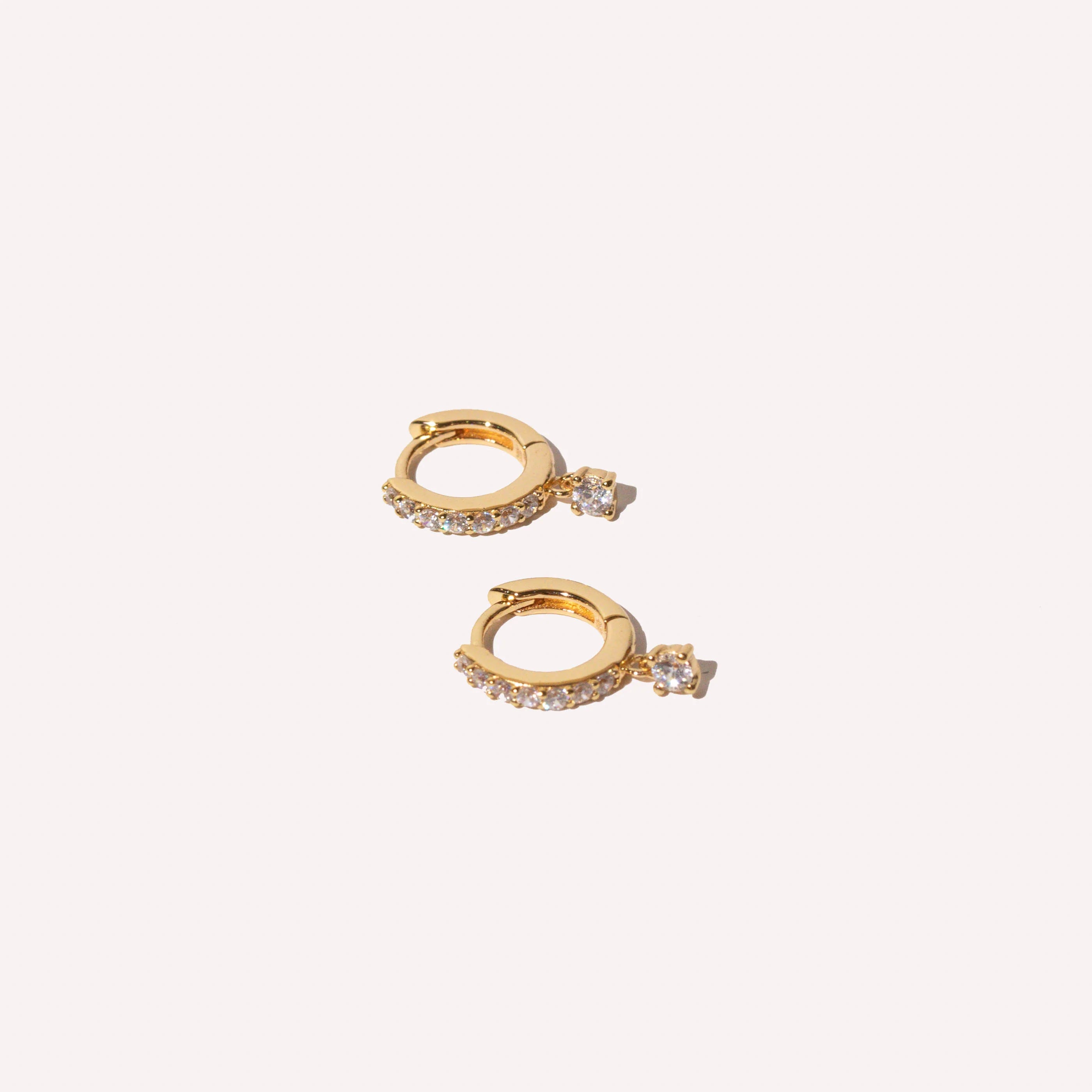Charm Crystal Huggies in Gold flat lay