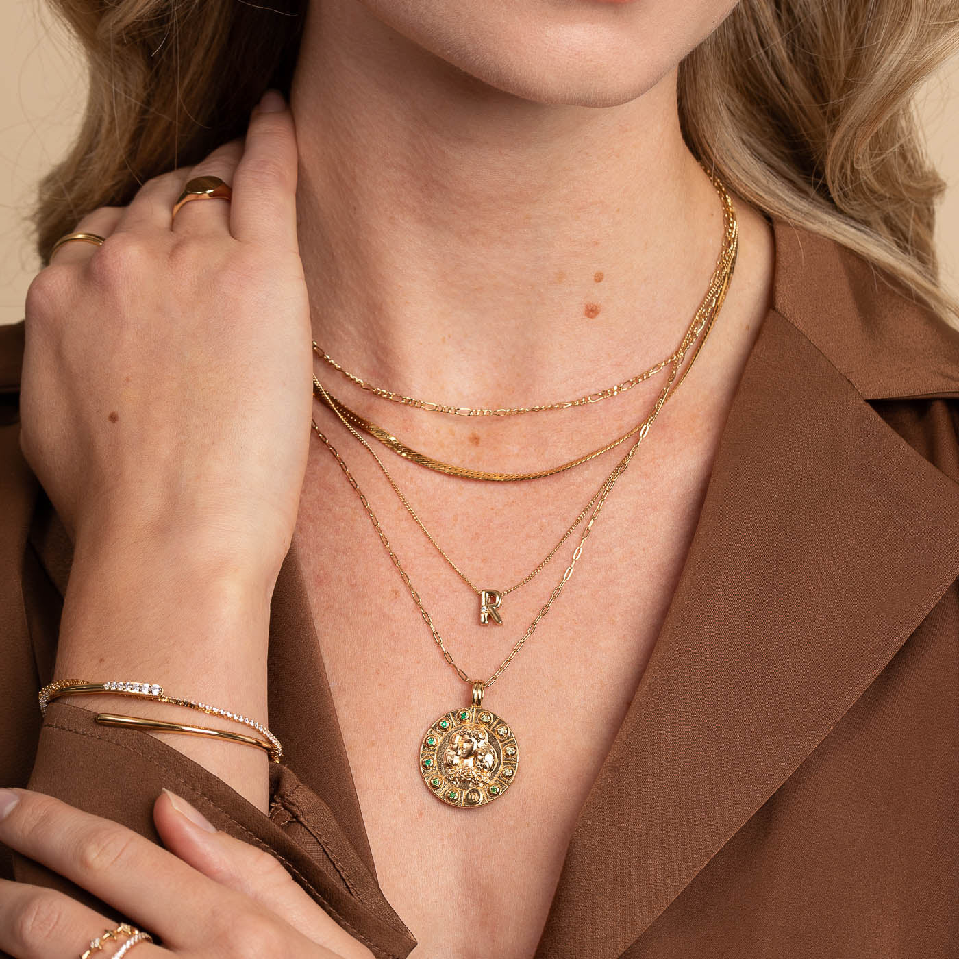 Virgo Bold Zodiac Pendant Necklace in Gold worn layered with necklaces