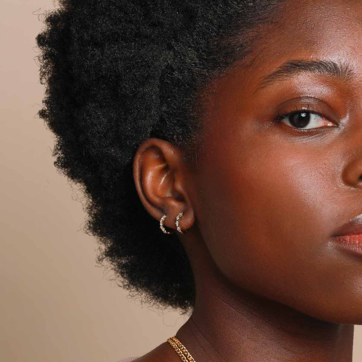 Worn shot of Navette Hoop 8mm in Gold in lobe piercing location