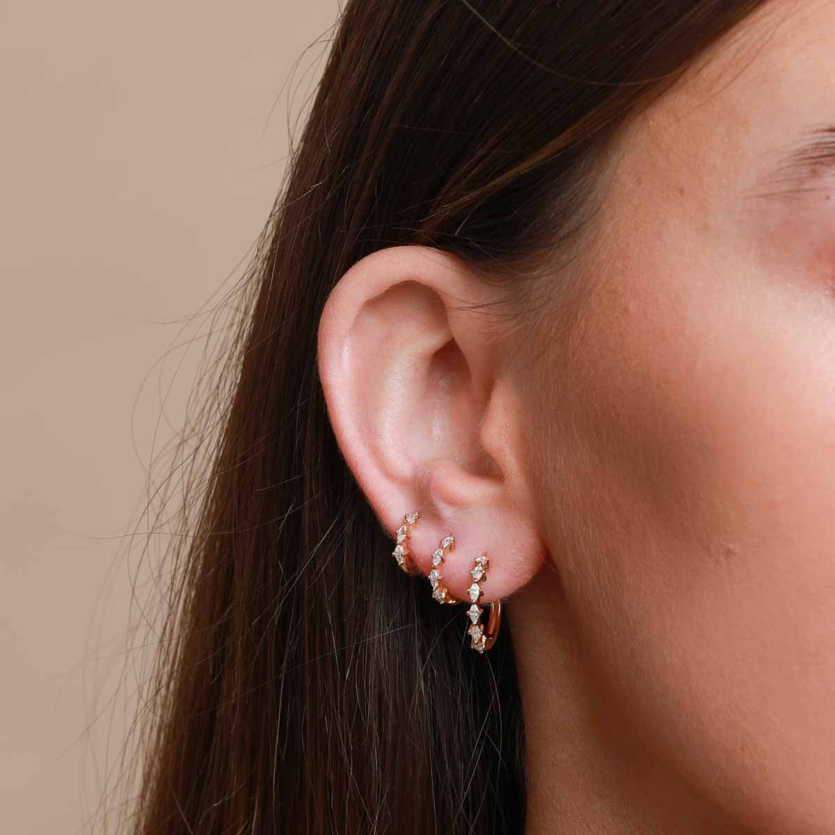 Worn shot of Navette Hoop 8mm in Gold in upper lobe location