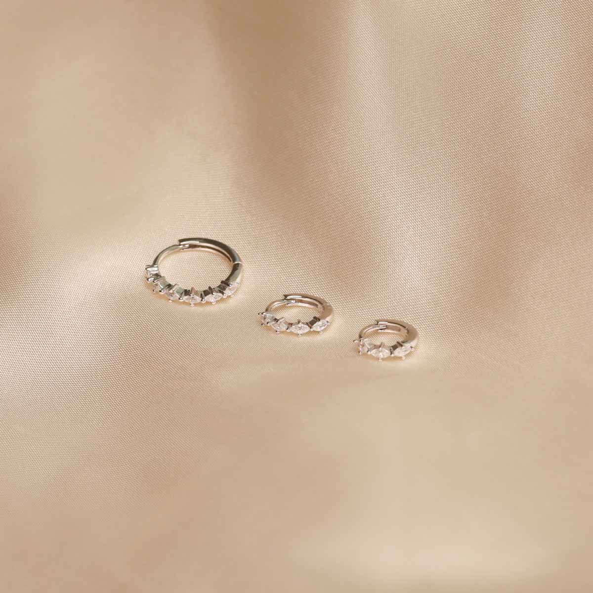 Flat lay shot of Navette Hoop in Silver in all available sizes