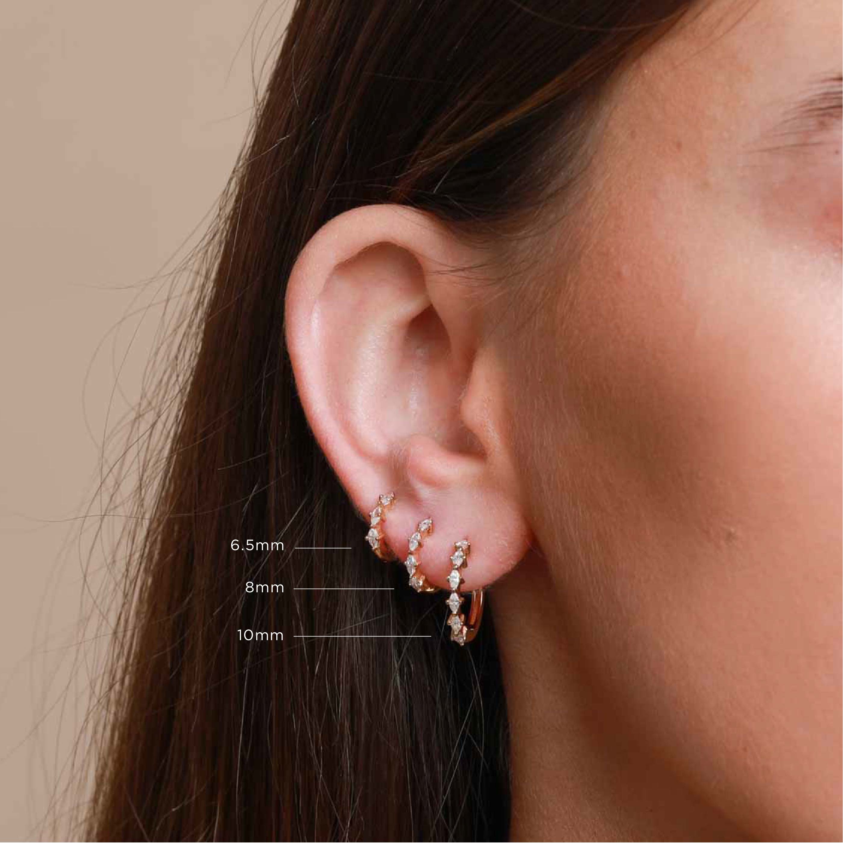 Worn shot of Navette Hoop 8mm in Gold in upper lobe location with sizes labelled