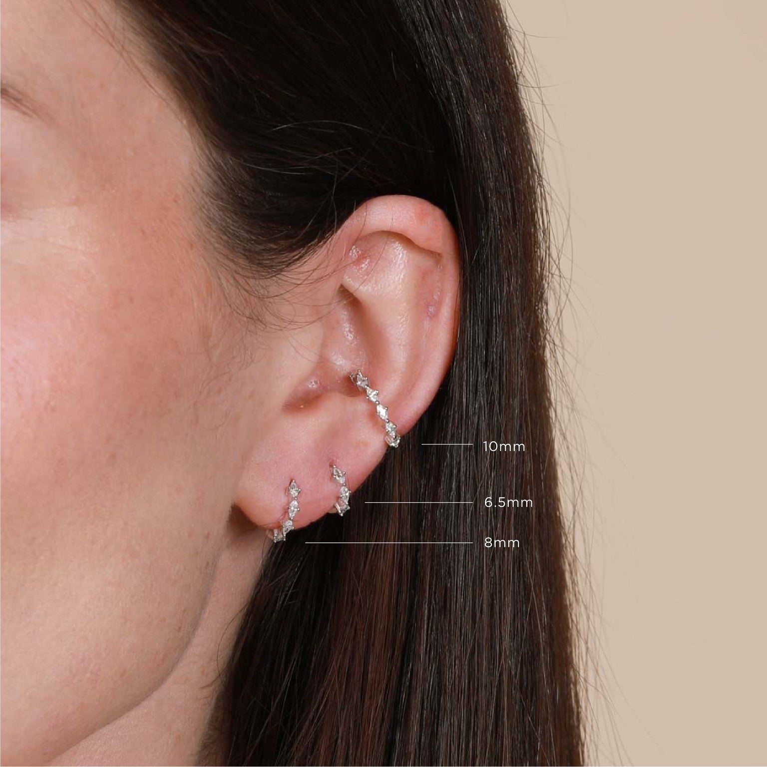 Worn shot of Navette Hoop 8mm in Silver in front lobe with sizes labelled