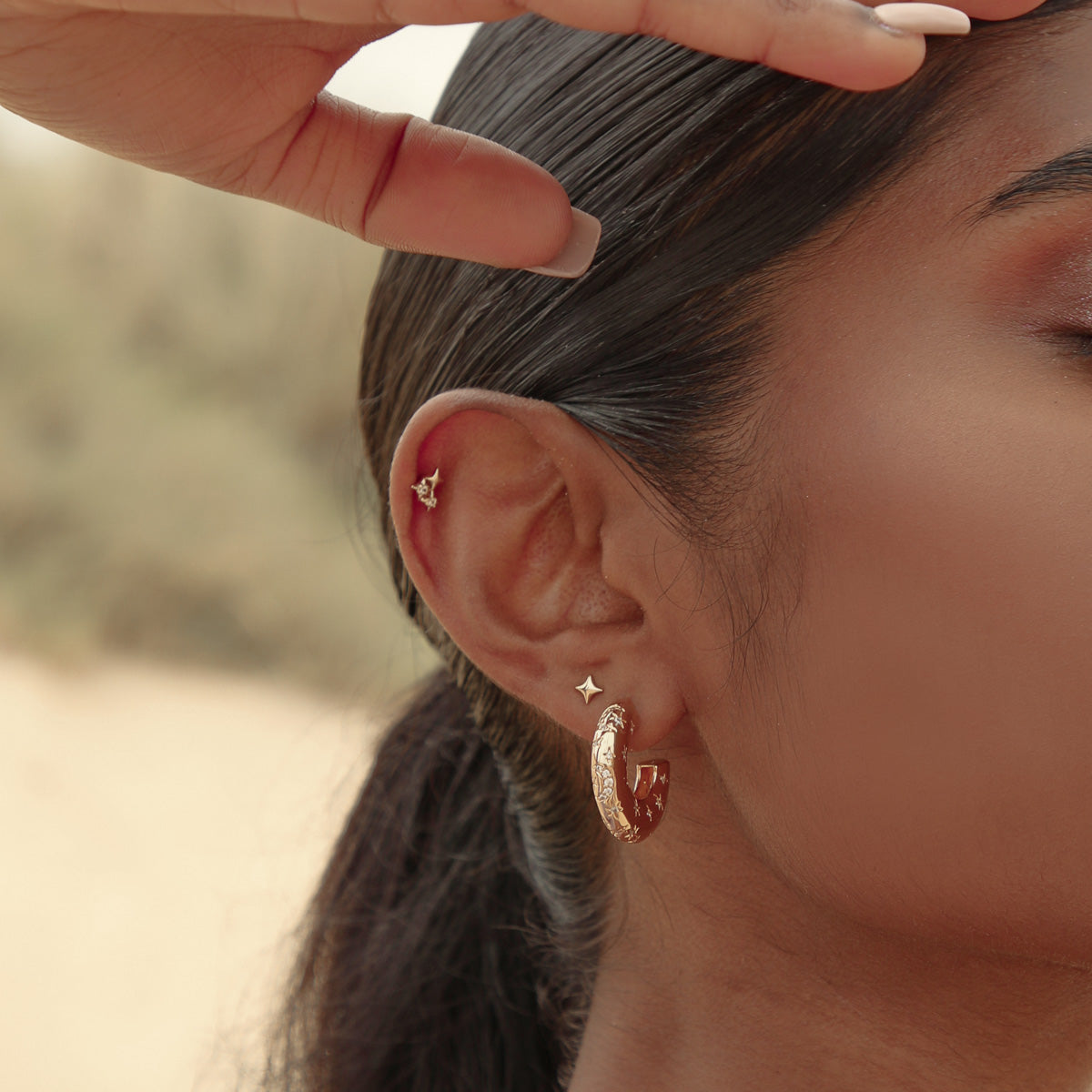 Cosmic Star Stud Earrings in Gold worn with Cosmic Dome Hoops