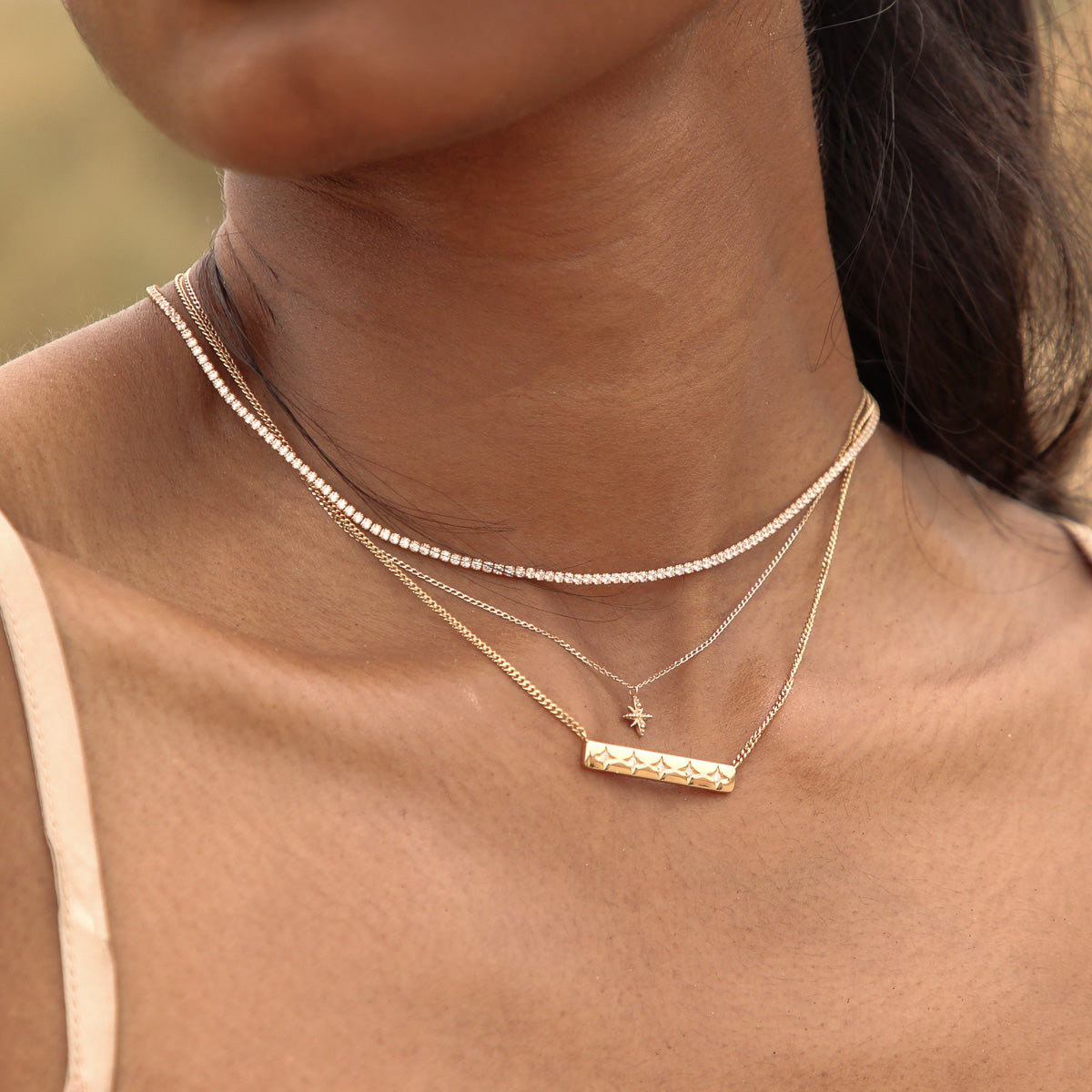 Cosmic Star Bar Necklace in Gold worn layered with tennis necklace and twilight star pendant necklace