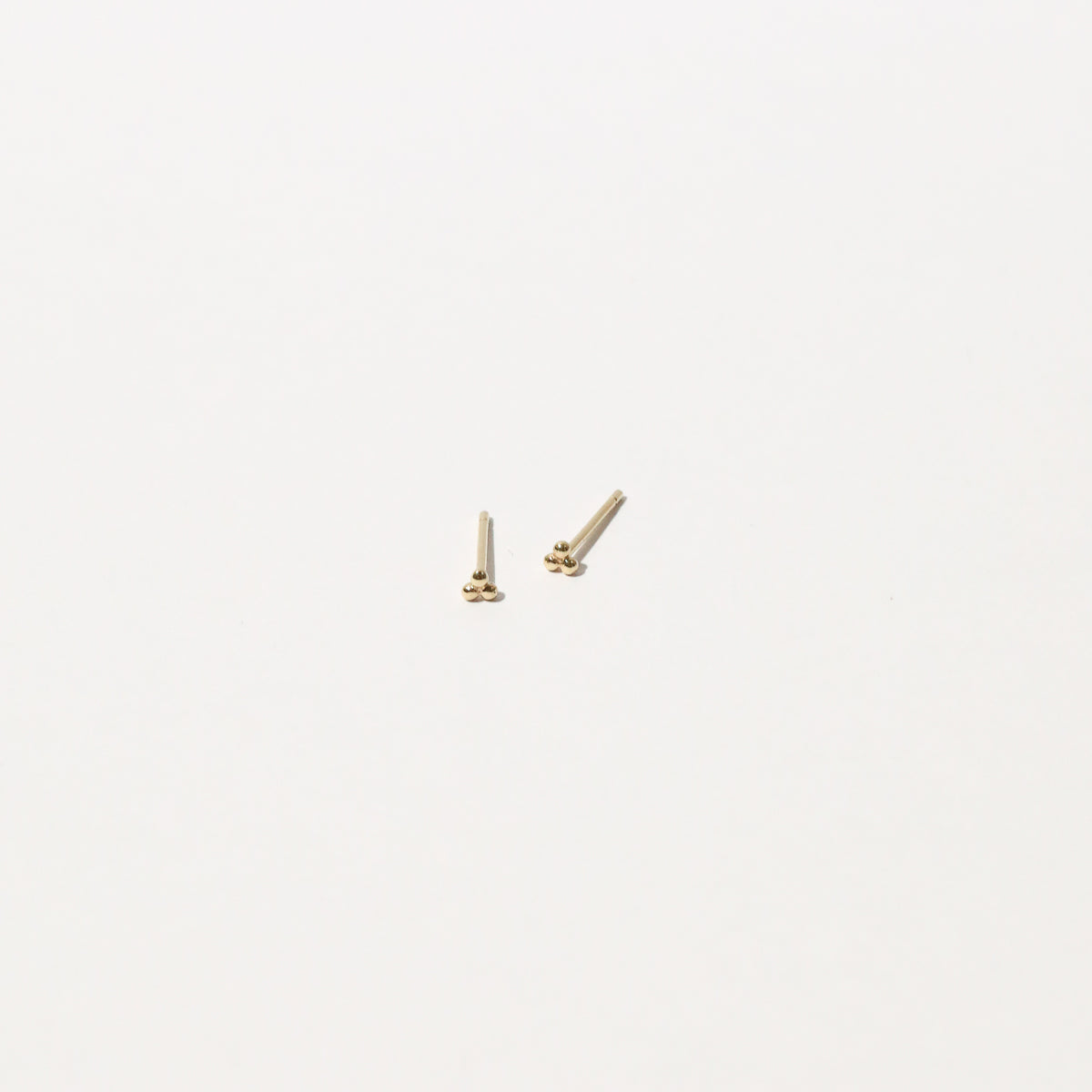 Trinity Stud Earrings in Solid Gold flat lay