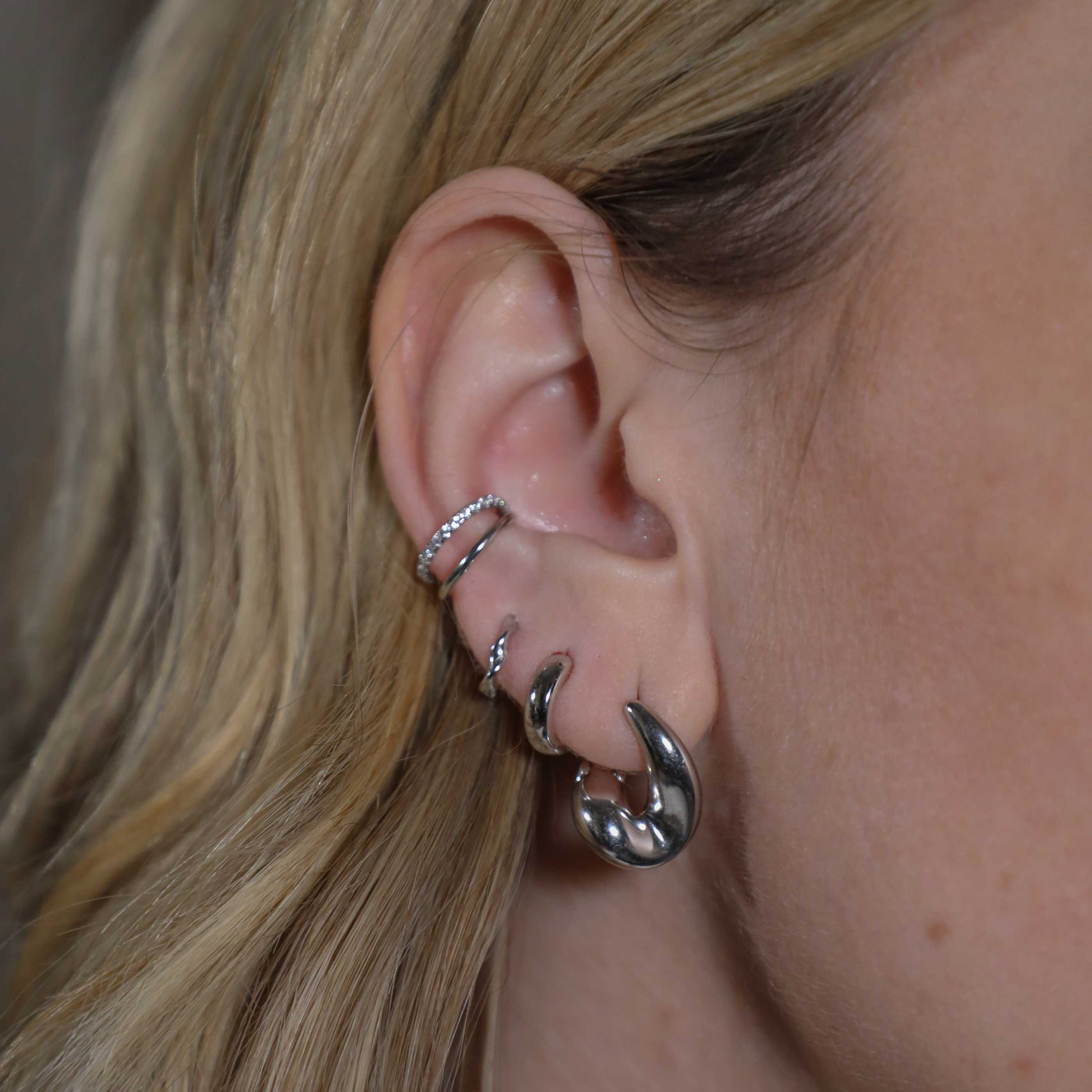 Illusion Crystal Ear Cuff in Silver worn with elemental huggies and bold huggies