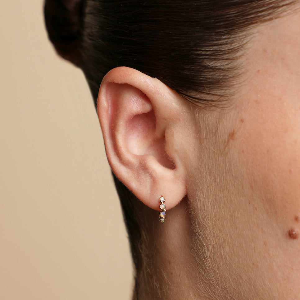 Opal Pear Bezel Huggies in Solid Gold