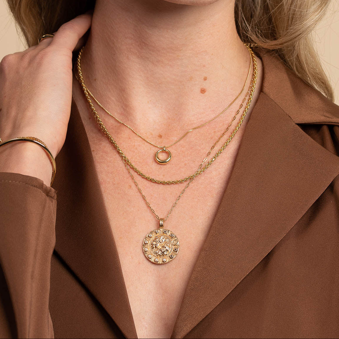 Bold Zodiac Gemini Pendant Necklace in Gold worn layered with halo necklace and rope chain necklace