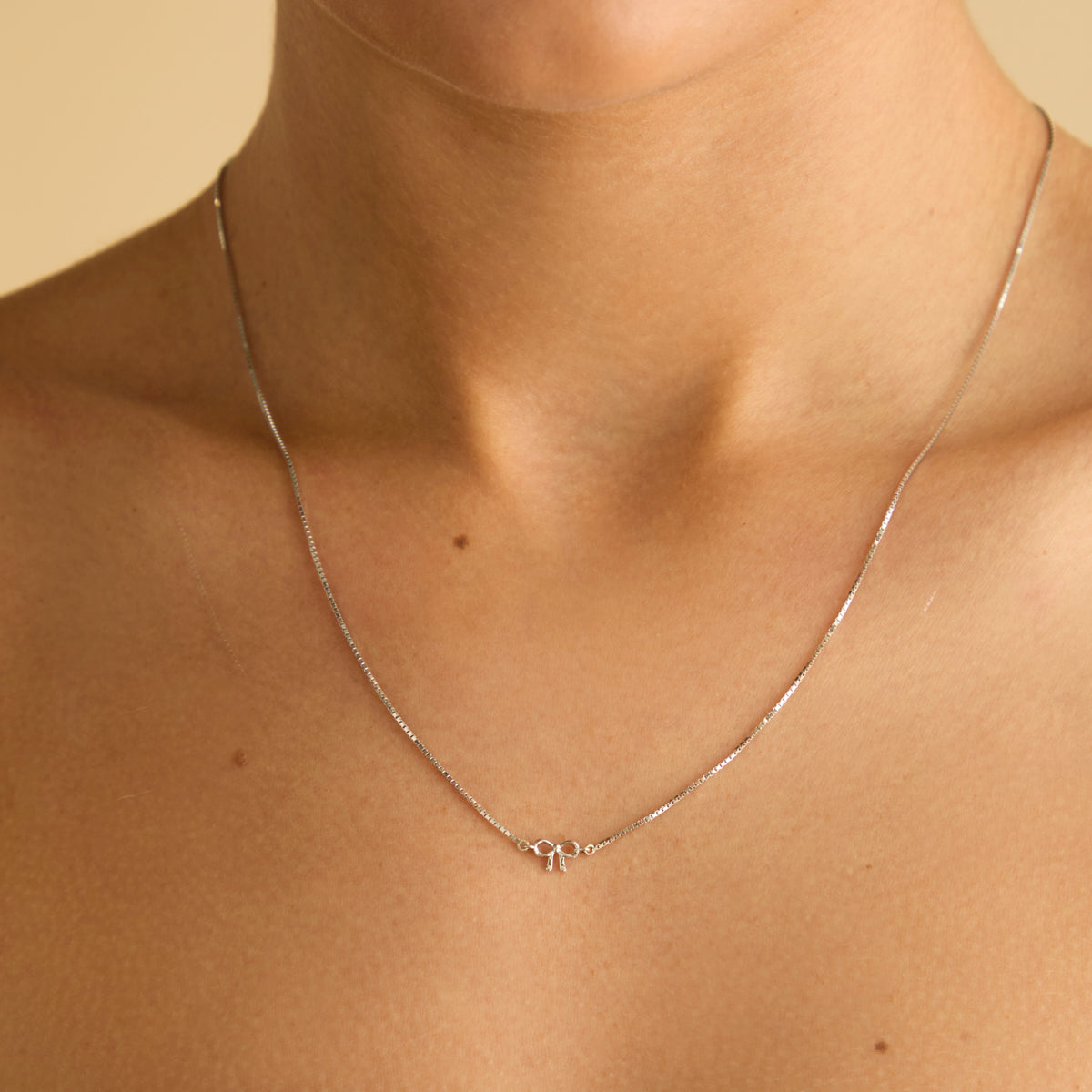 Bow Charm Necklace in Solid White Gold