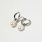 Serenity Pearl Charm Hoops in Silver flat lay