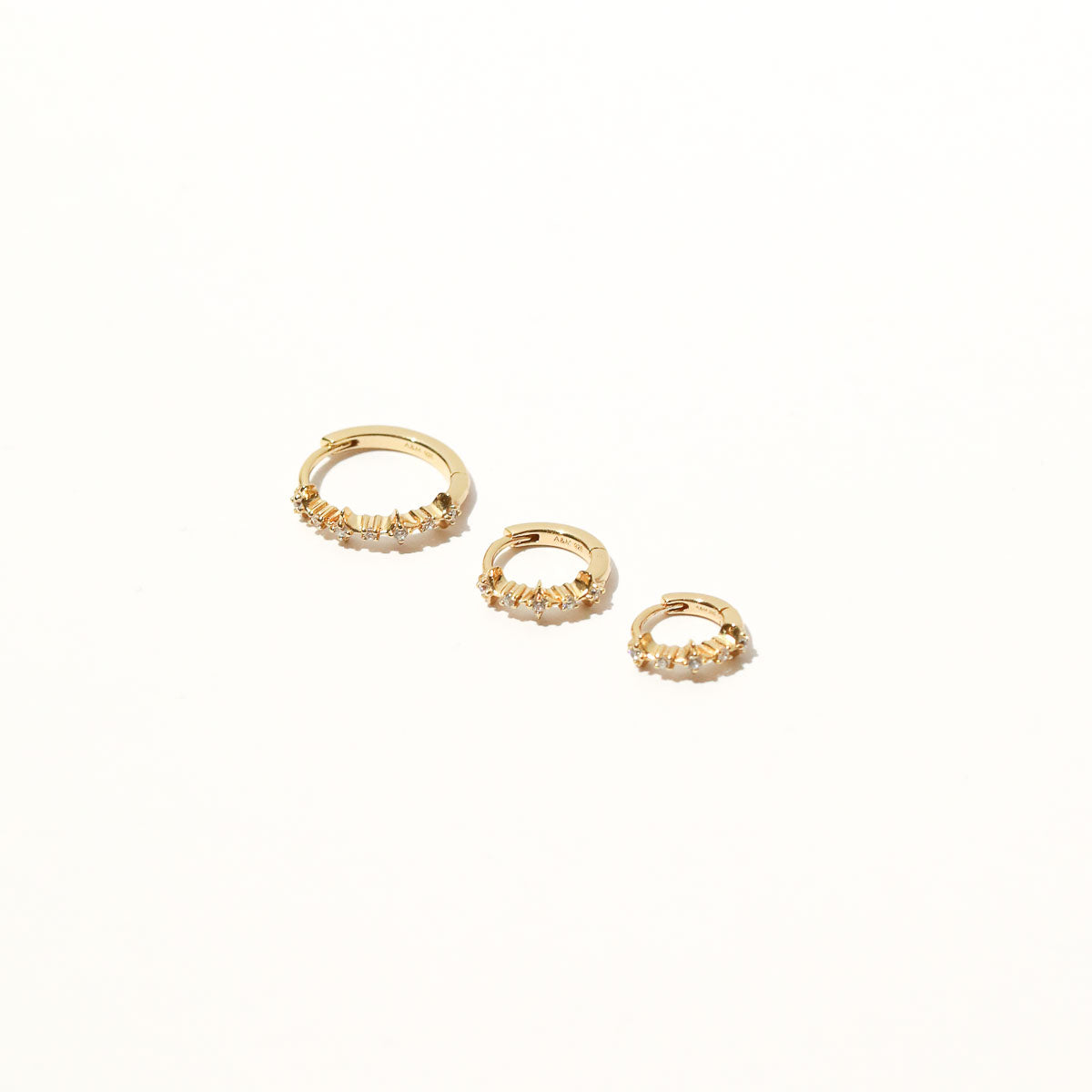 Cosmic Star 6.5mm, 8mm & 11.5mm Hoops in Gold flat lay