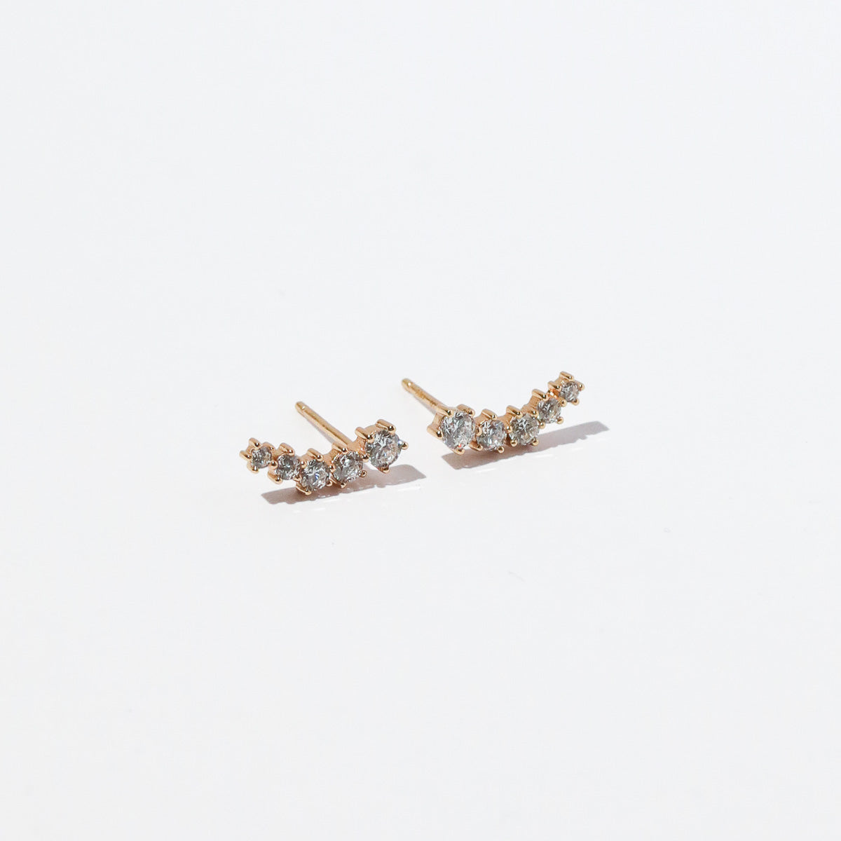 Illume Crystal Climber Stud Earrings in Gold flat lay