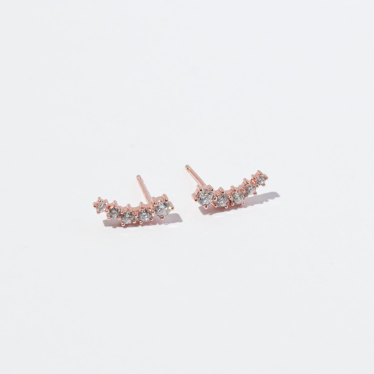 Illume Crystal Climber Stud Earrings in Rose Gold flat lay