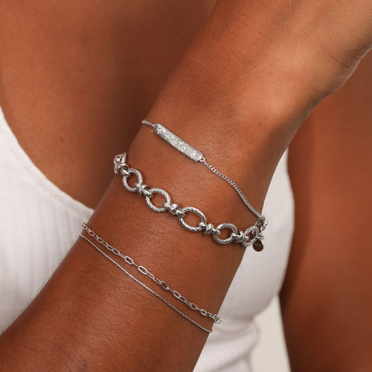 Cosmic Star Bar Bracelet in Silver worn stacked with other bracelets