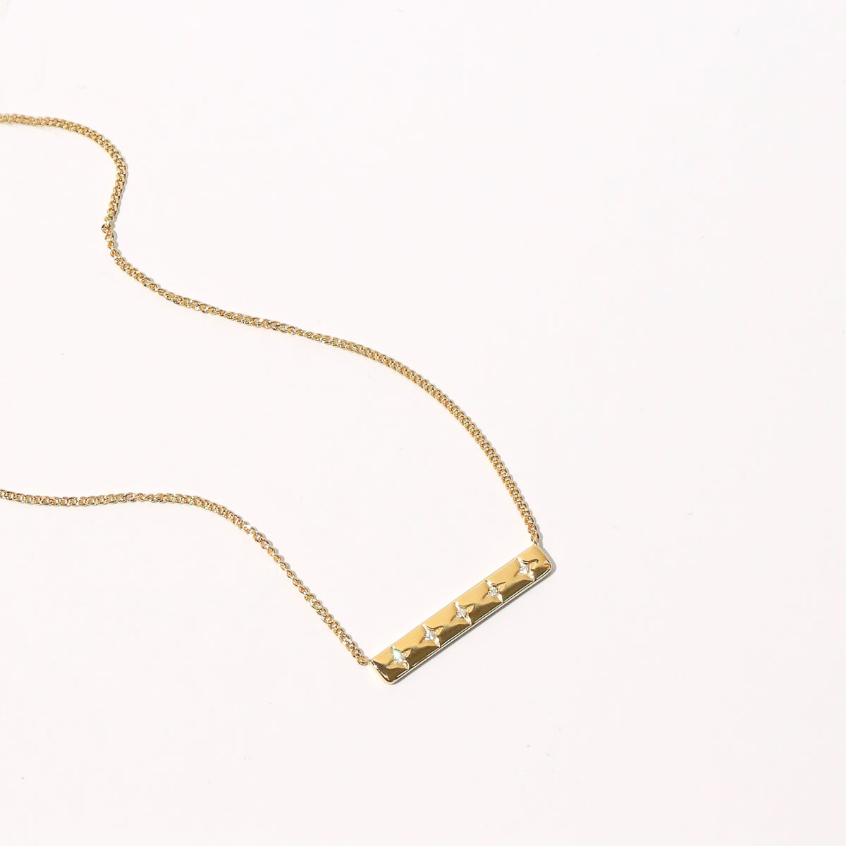 Cosmic Star Bar Necklace in Gold flat lay shot