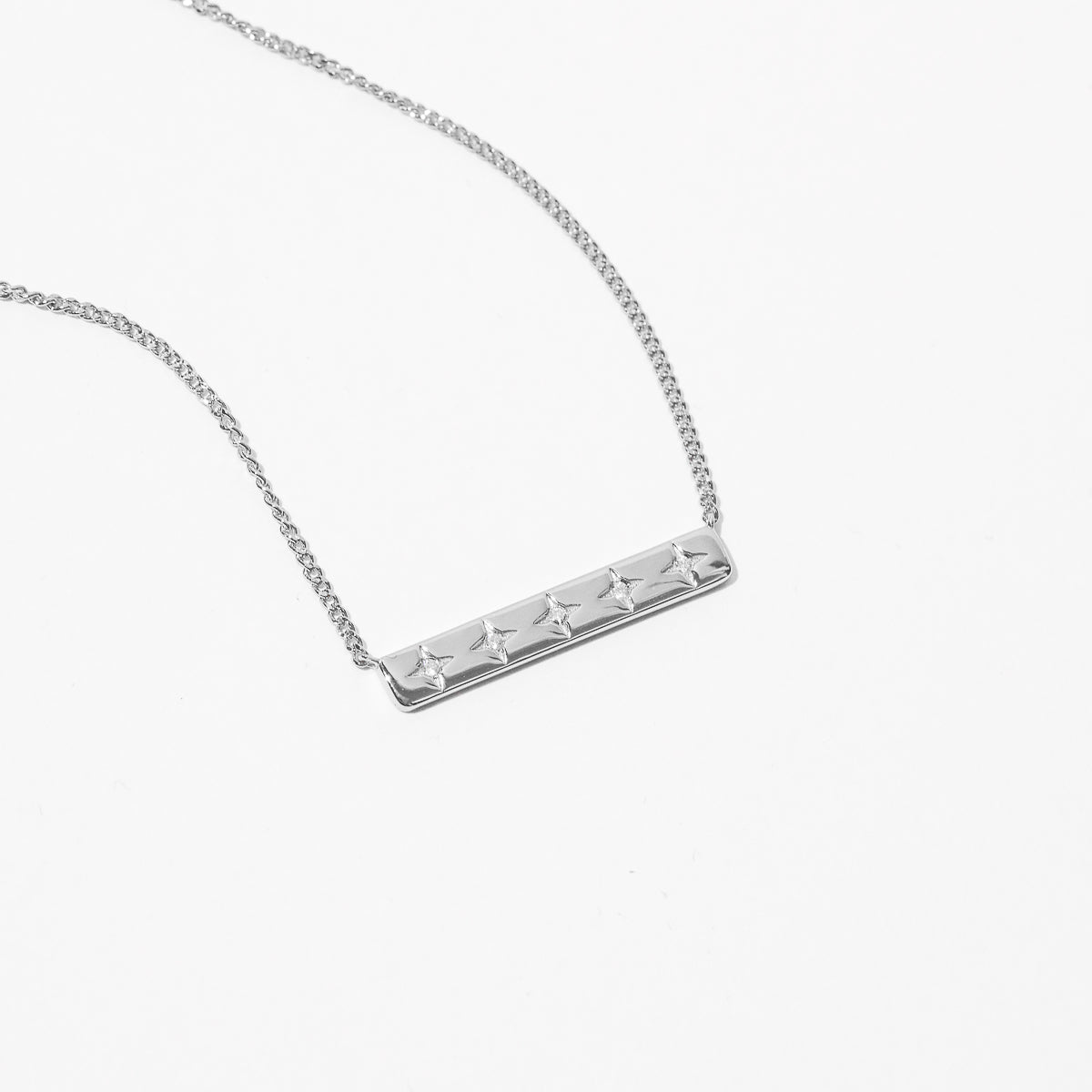 Cosmic Star Bar Necklace in Silver flat lay shot