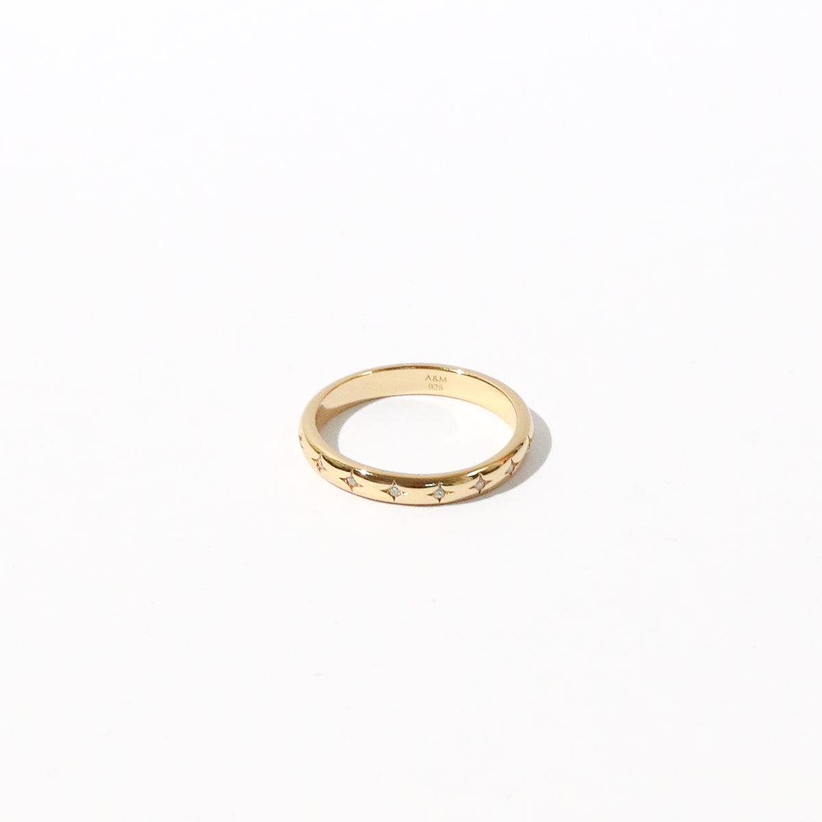 Cosmic Star Band Ring in Gold flat lay shot