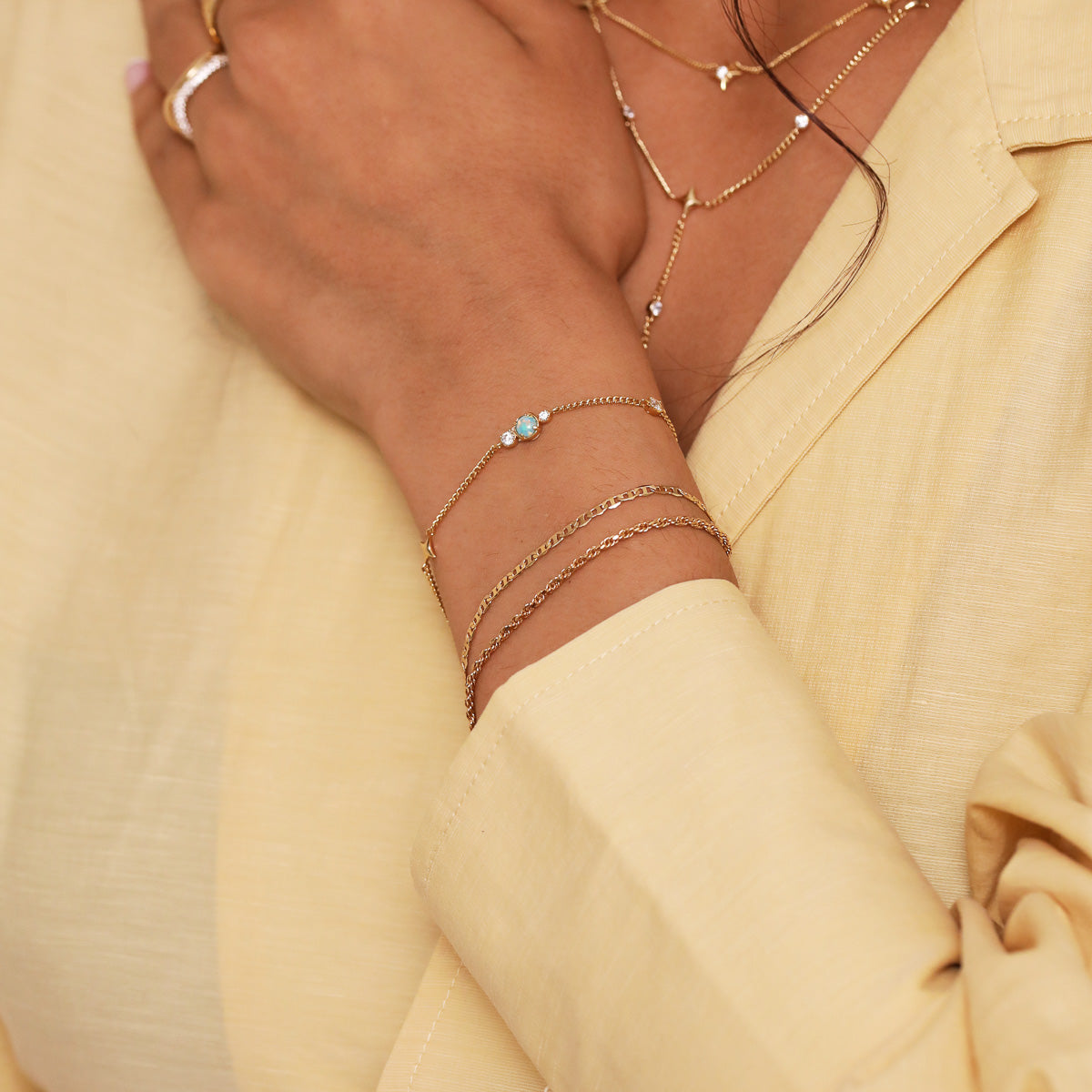 Cosmic Star Opal Bracelet in Gold worn stacked with bracelets