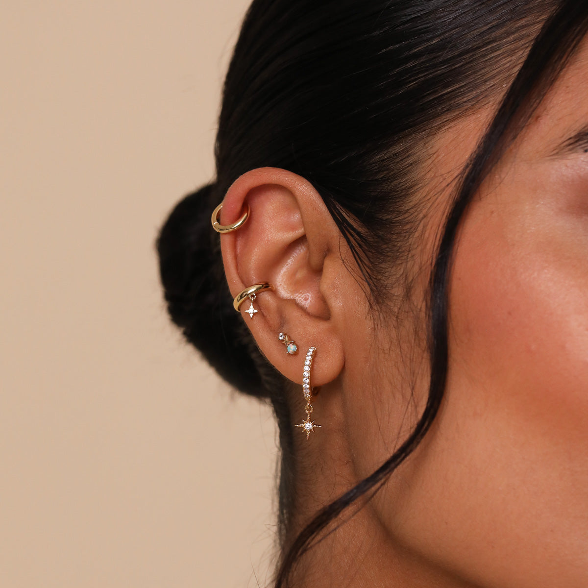 Cosmic Star Opal Stud Earrings in Gold worn with other earrings