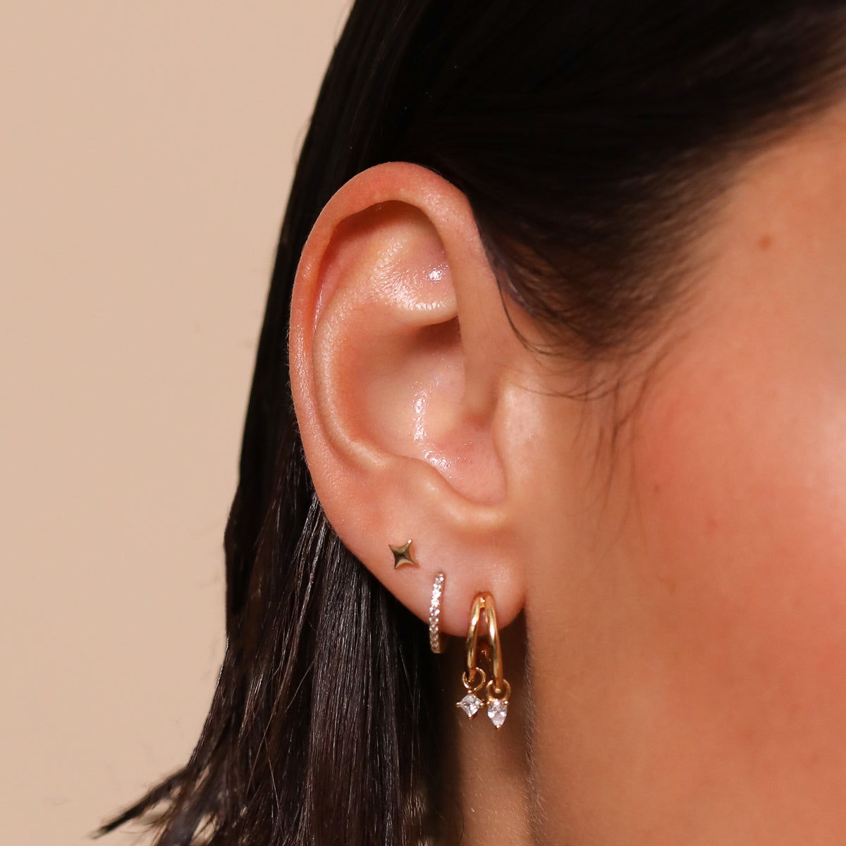 Celestial Crystal Huggies in Gold worn stacked with other earrings