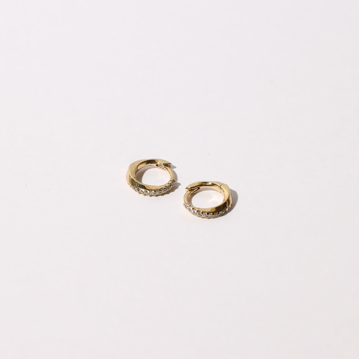 Orbit Crystal Huggies in Gold flat lay