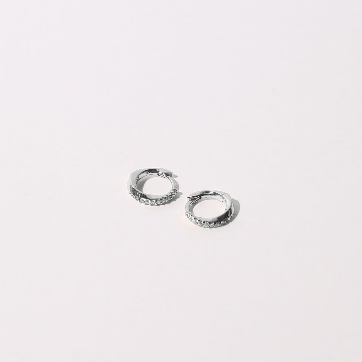 Orbit Crystal Huggies in Silver Flat Lay