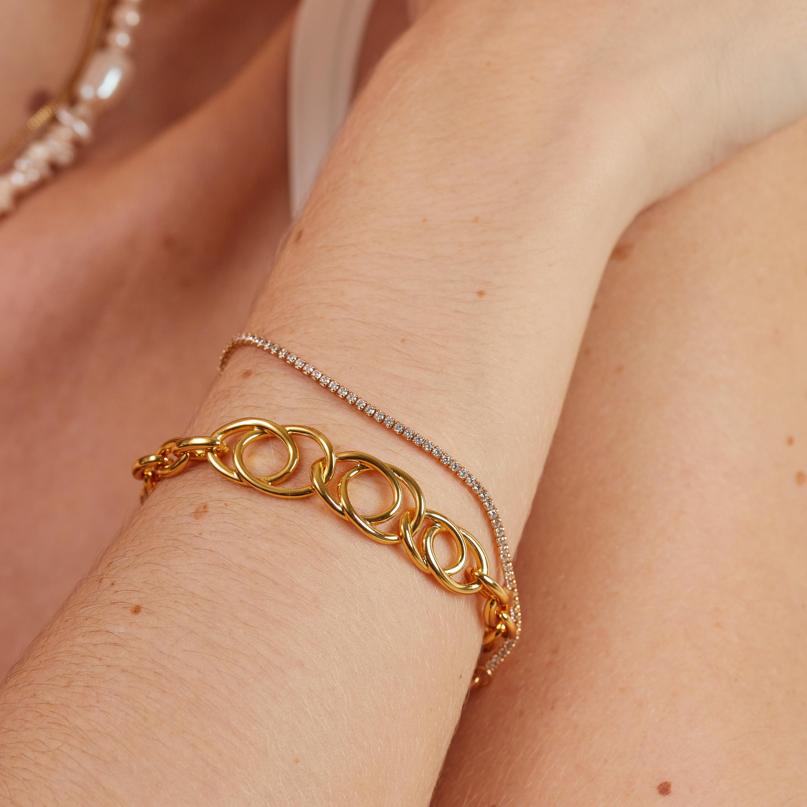 Orbit Chain Bracelet in Gold worn with gold tennis bracelet