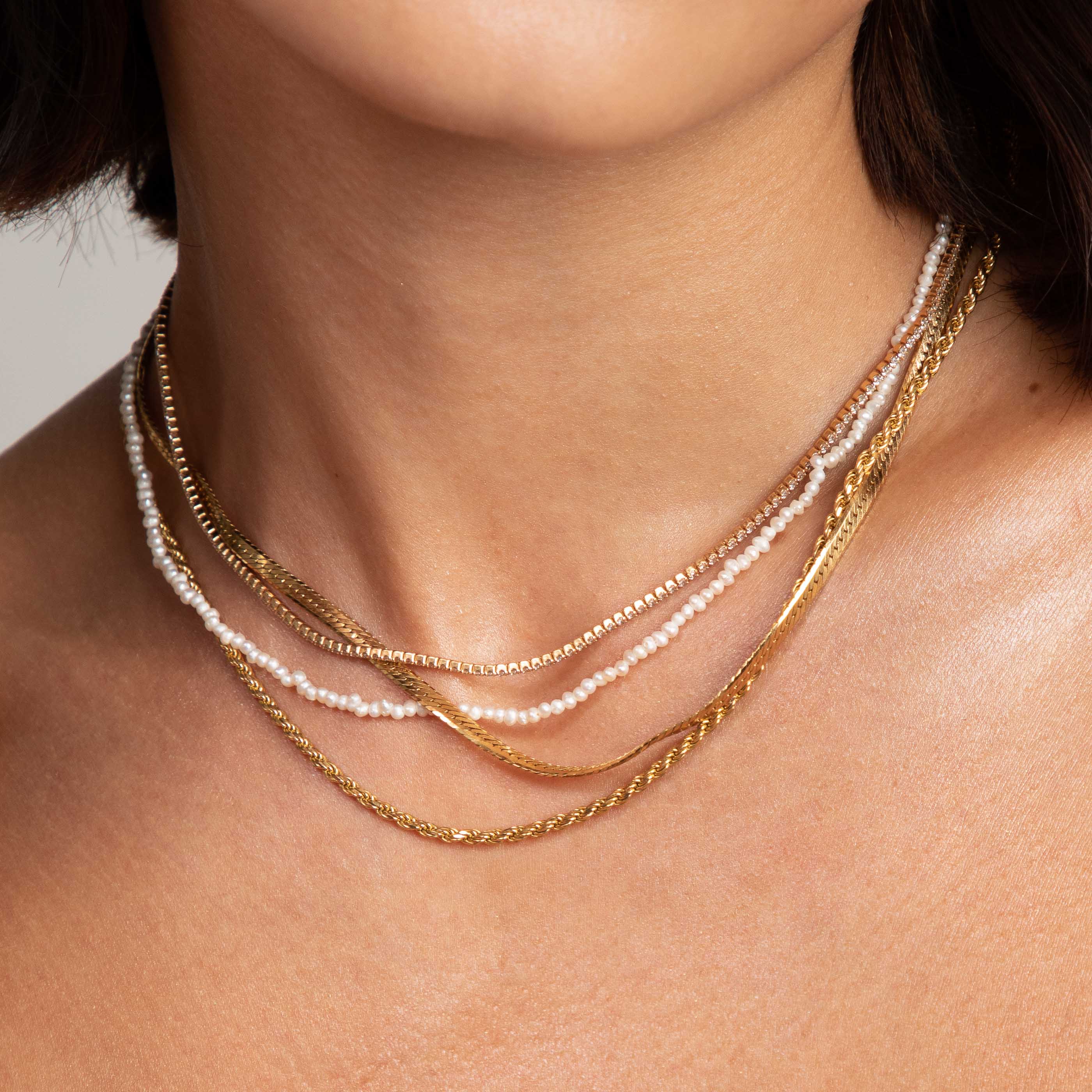 Radiant Pearl Necklace in Gold worn layered with necklaces