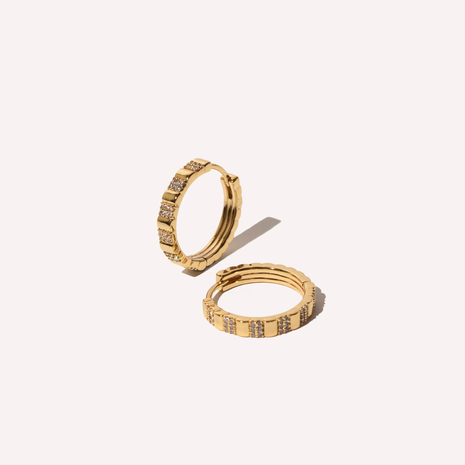 Pleated Crystal Hoops in Gold flat lay
