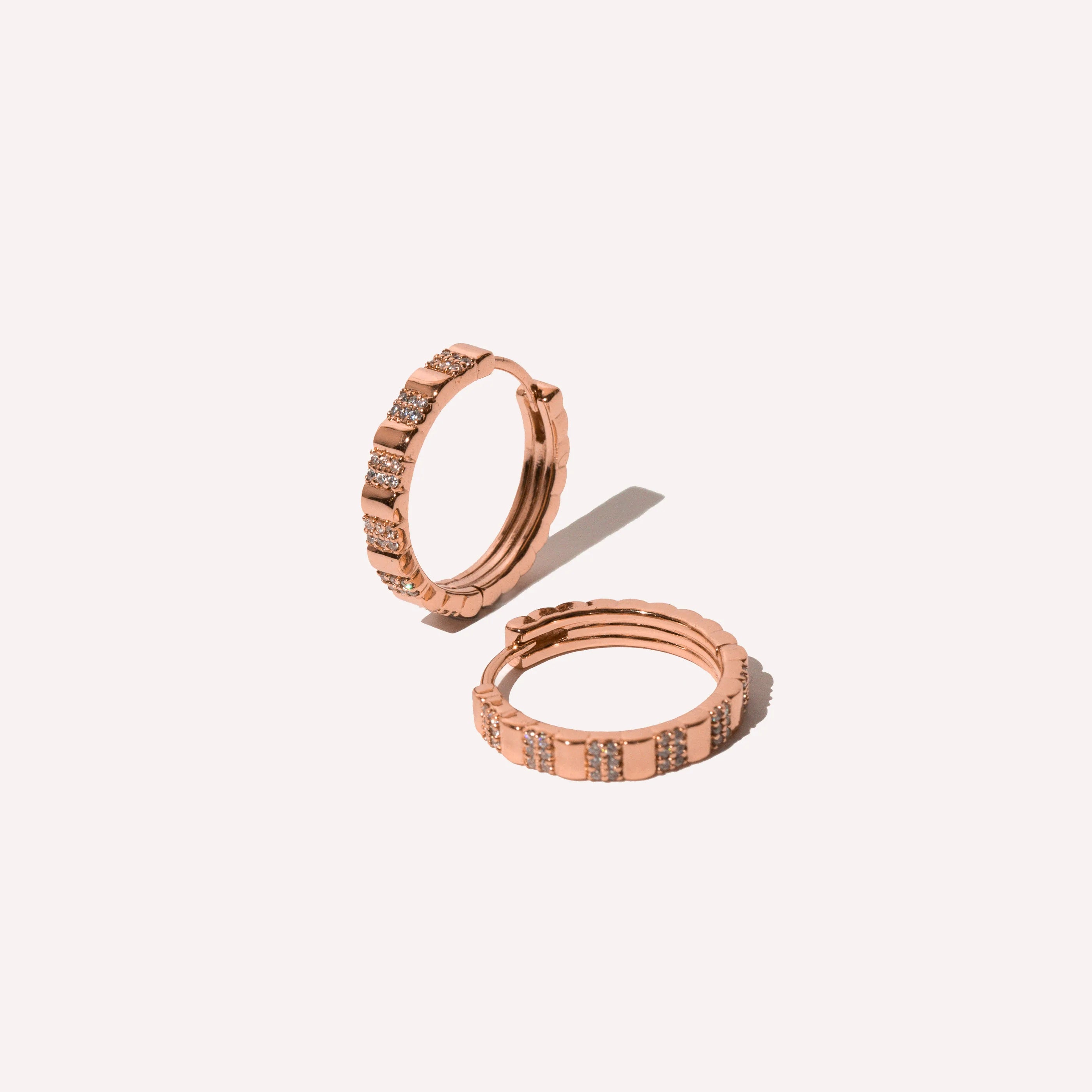 Pleated Crystal Hoops in Rose Gold flat lay shot