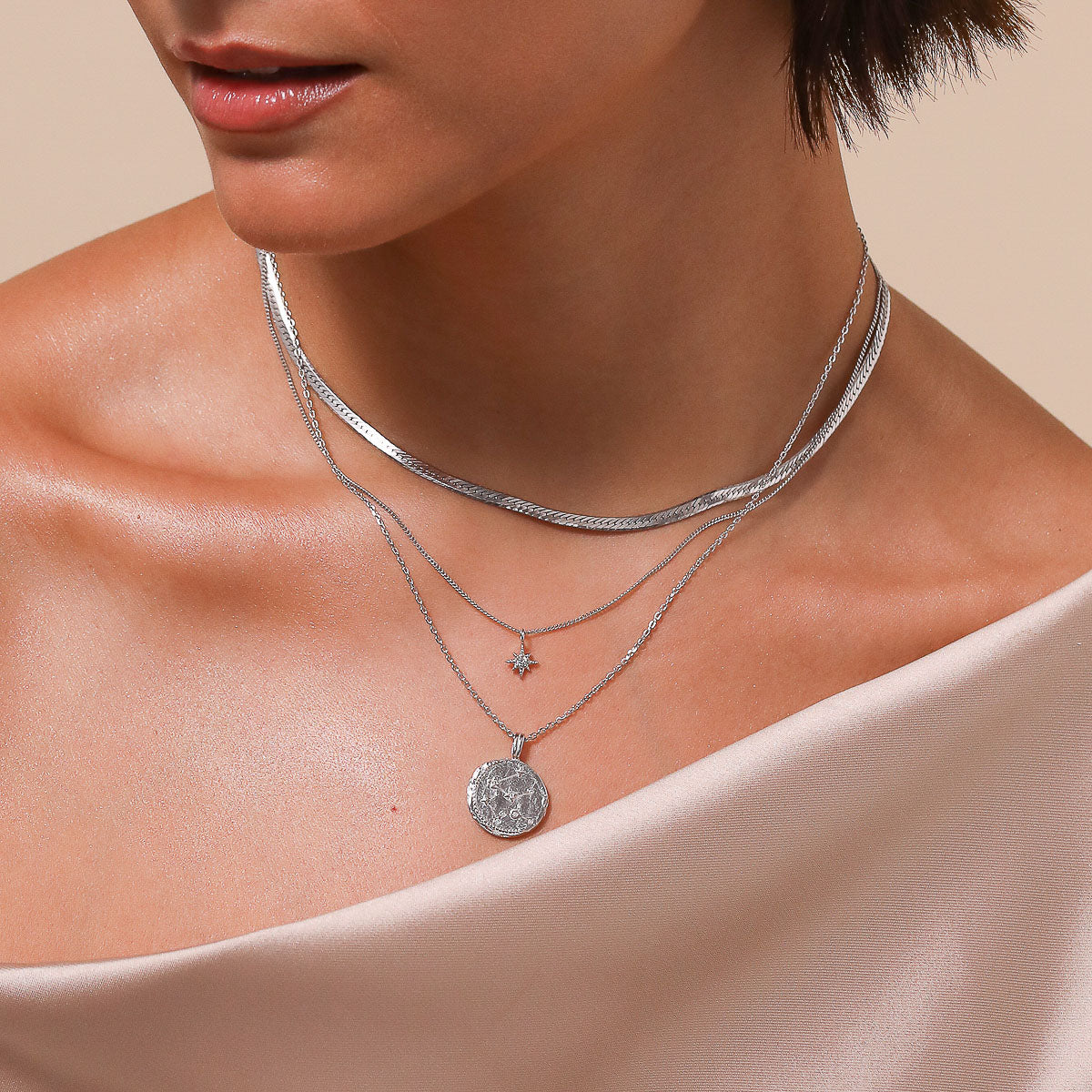 Aquarius Zodiac Pendant Necklace in Silver worn layered with necklaces