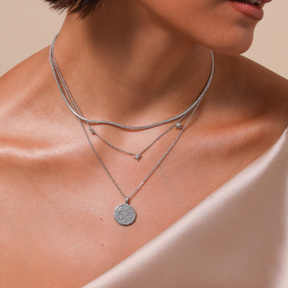 Aries Zodiac Pendant Necklace in Silver worn layered with necklaces
