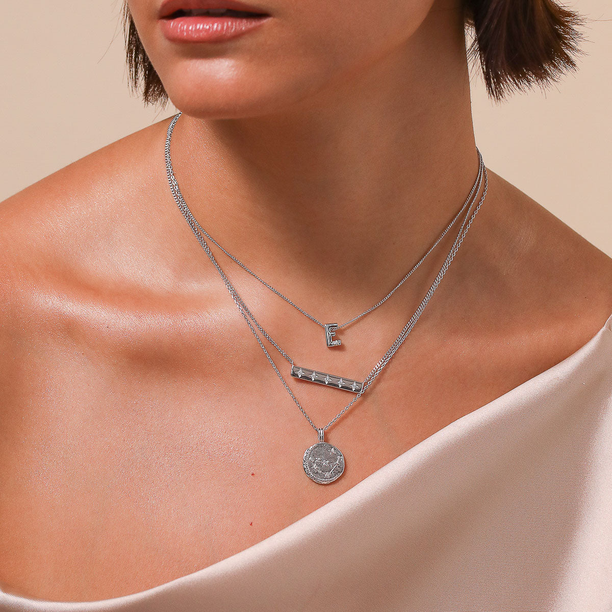 Capricorn Zodiac Pendant Necklace in Silver worn layered with necklaces