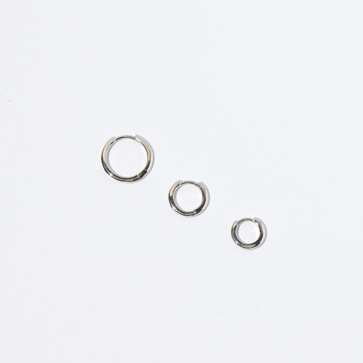 Essential Hoop in Silver flat lay with other sizes