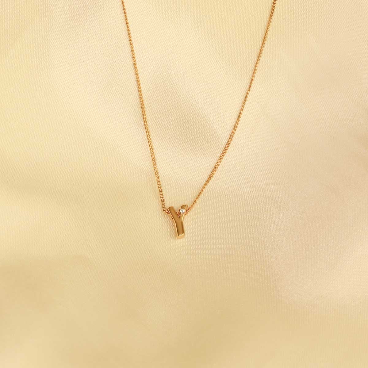 Flat lay shot of Y Initial Pendant Necklace in Gold