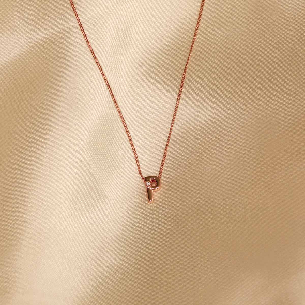 Flat lay shot of P Initial Pendant Necklace in Rose Gold