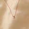 Flat lay shot of X Initial Pendant Necklace in Rose Gold