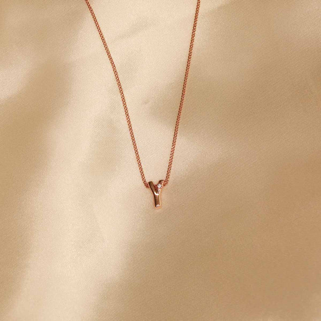 Flat lay shot of Y Initial Pendant Necklace in Rose Gold