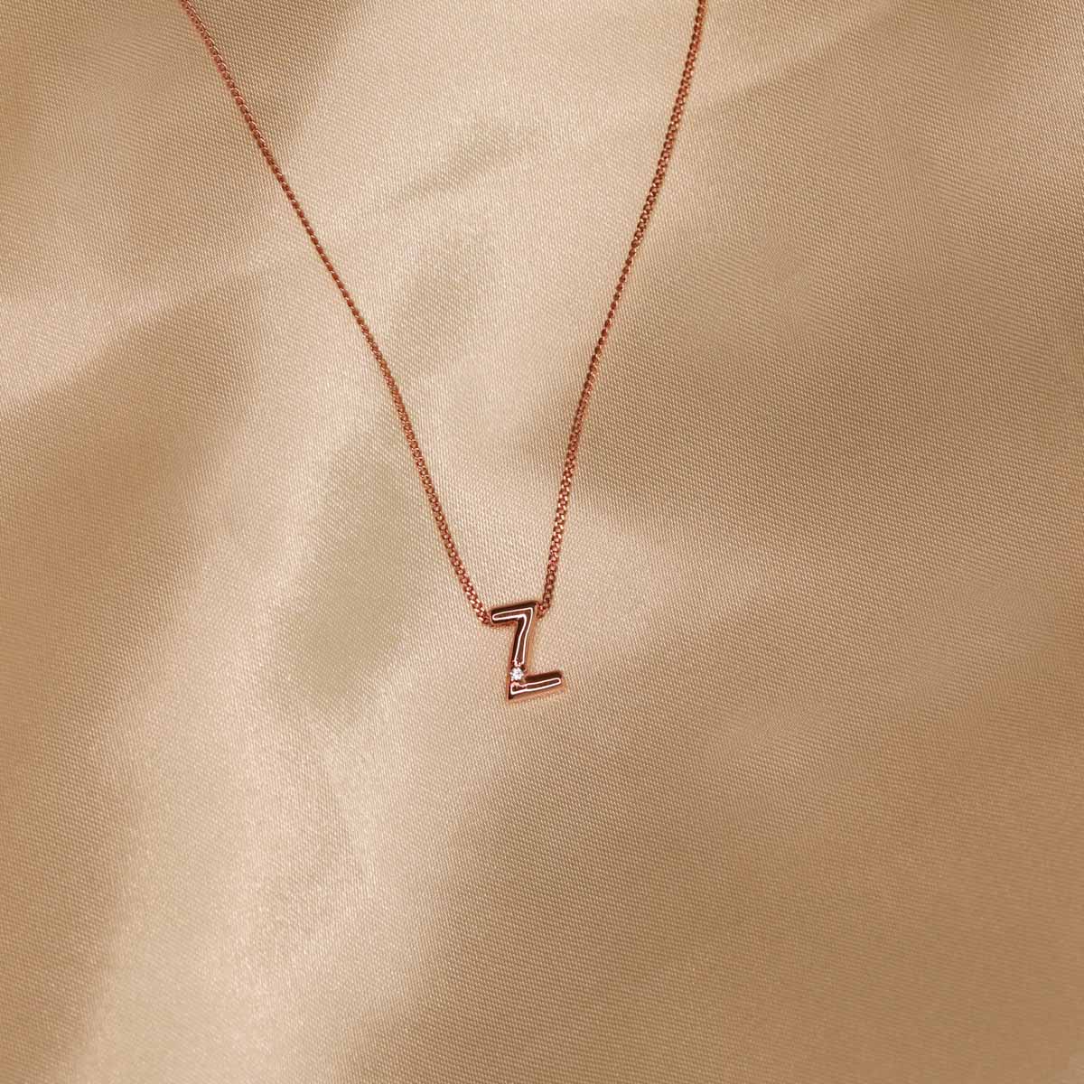 Flat lay shot of Z Initial Pendant Necklace in Rose Gold