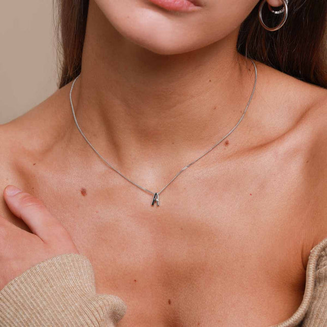 A Initial Pendant Necklace in Silver  worn